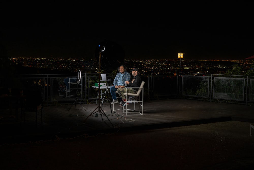 2 person sitting on chair during night time