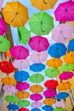 multi colored umbrella hanging on wire during daytime