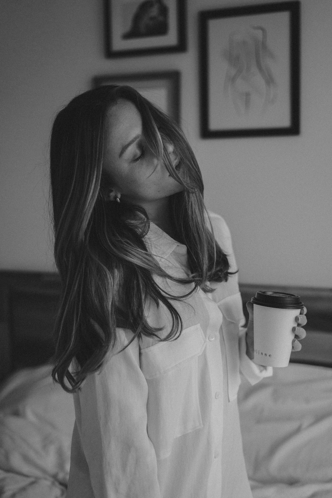 woman in white coat holding ceramic mug