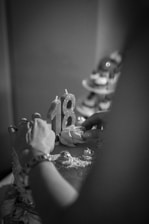 grayscale photo of person holding white textile