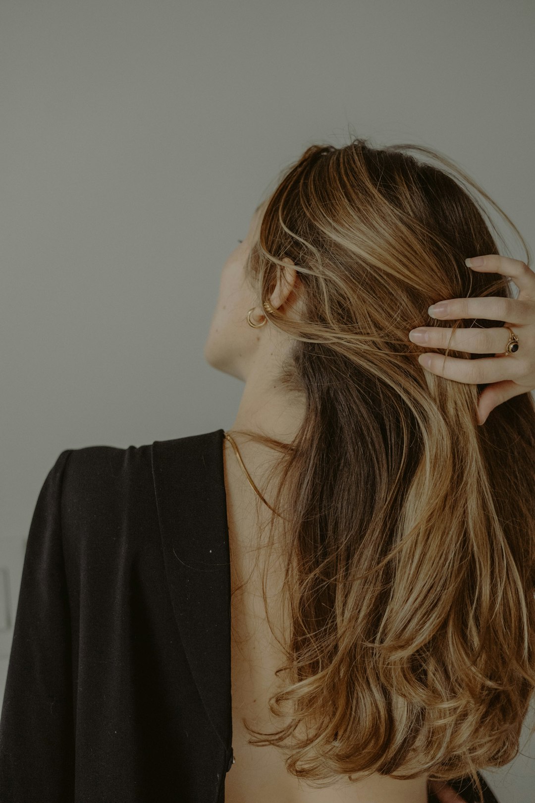 woman in black shirt covering her face with hair