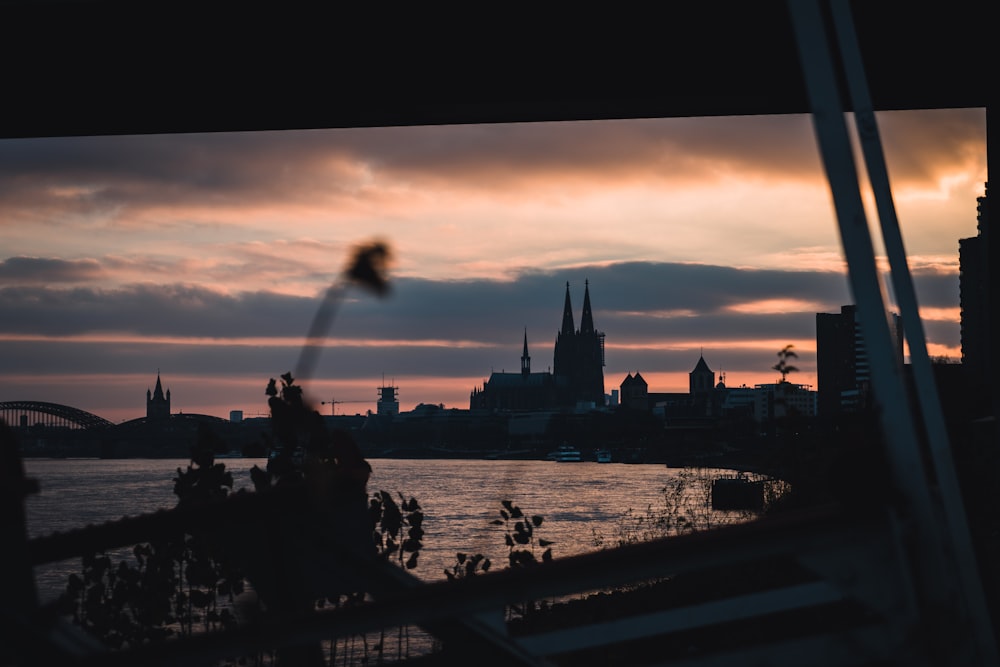 silhouette of people on bridge during sunset