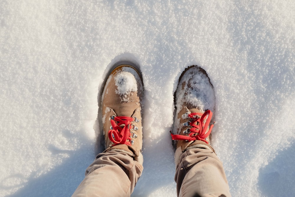 person wearing brown pants and white and red sneakers