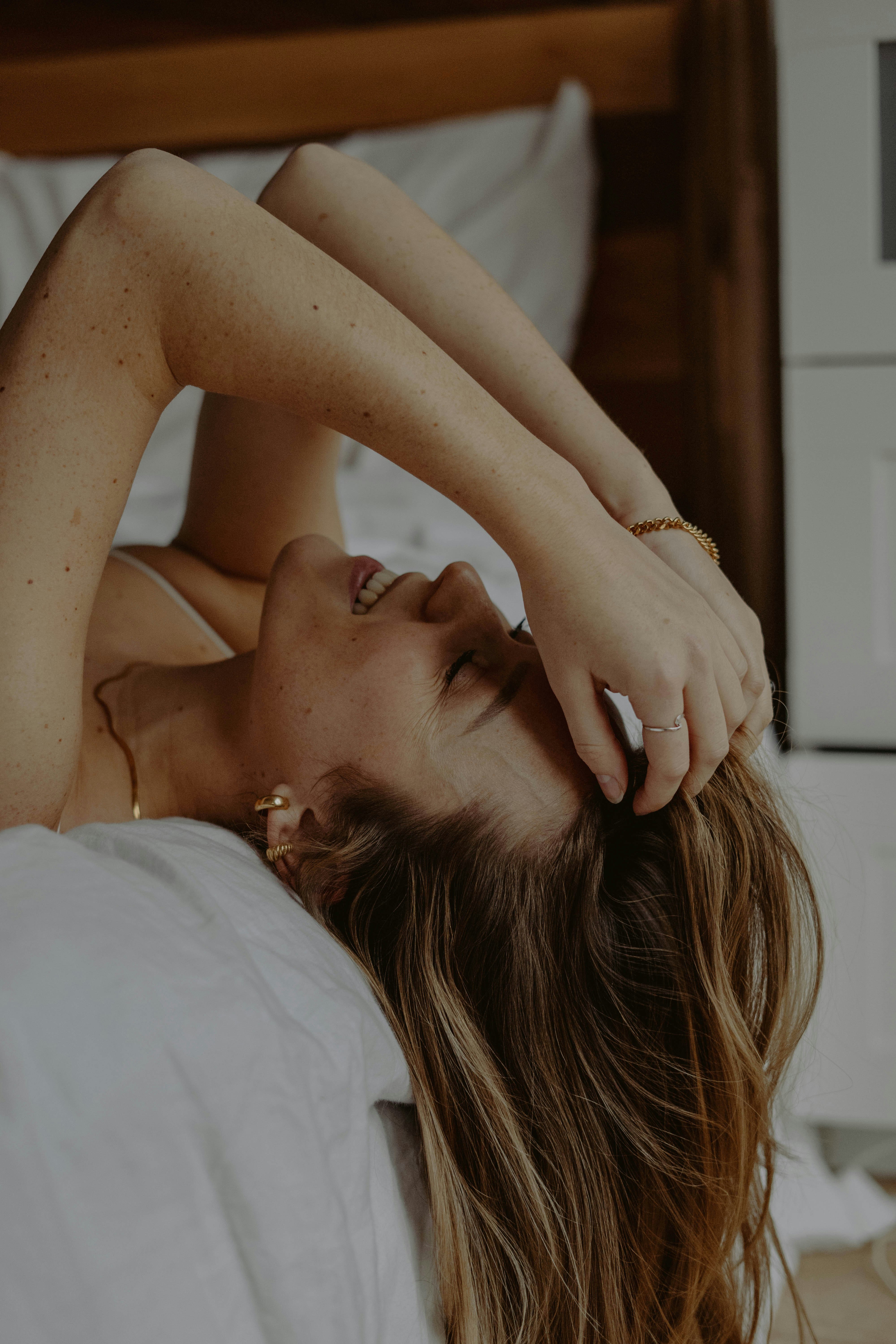 topless woman lying on bed