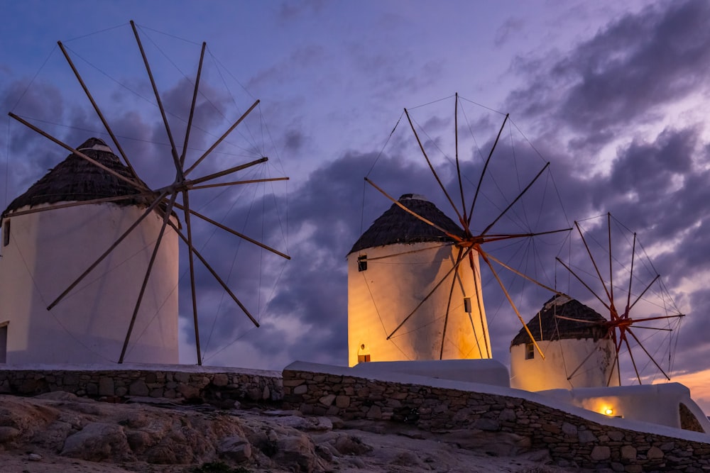 white wind turbines on brown rocky mountain under white cloudy sky during daytime