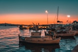 white and brown boat on sea during sunset