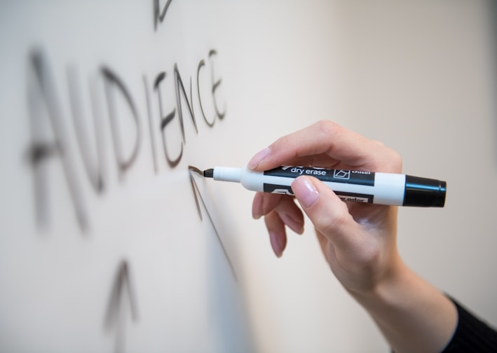 person holding white and blue click pen