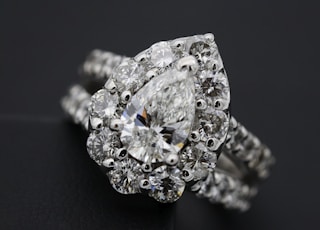 silver diamond studded ring on black textile