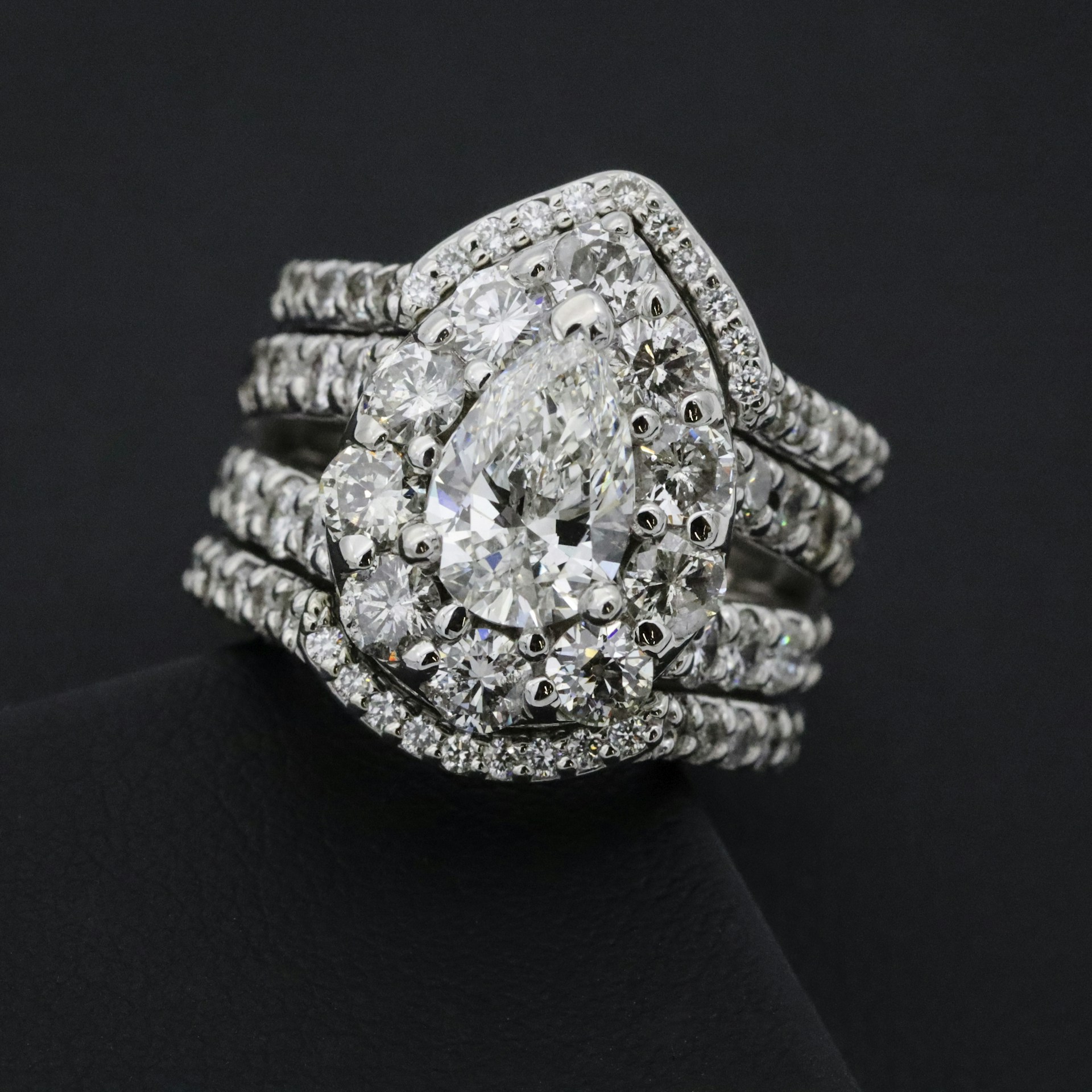 silver diamond studded ring on black textile
