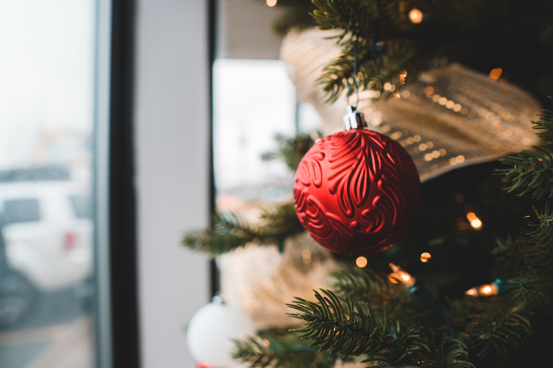 red and white baubles on green christmas tree