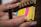 A close-up of hands writing ideas on colorful sticky notes.