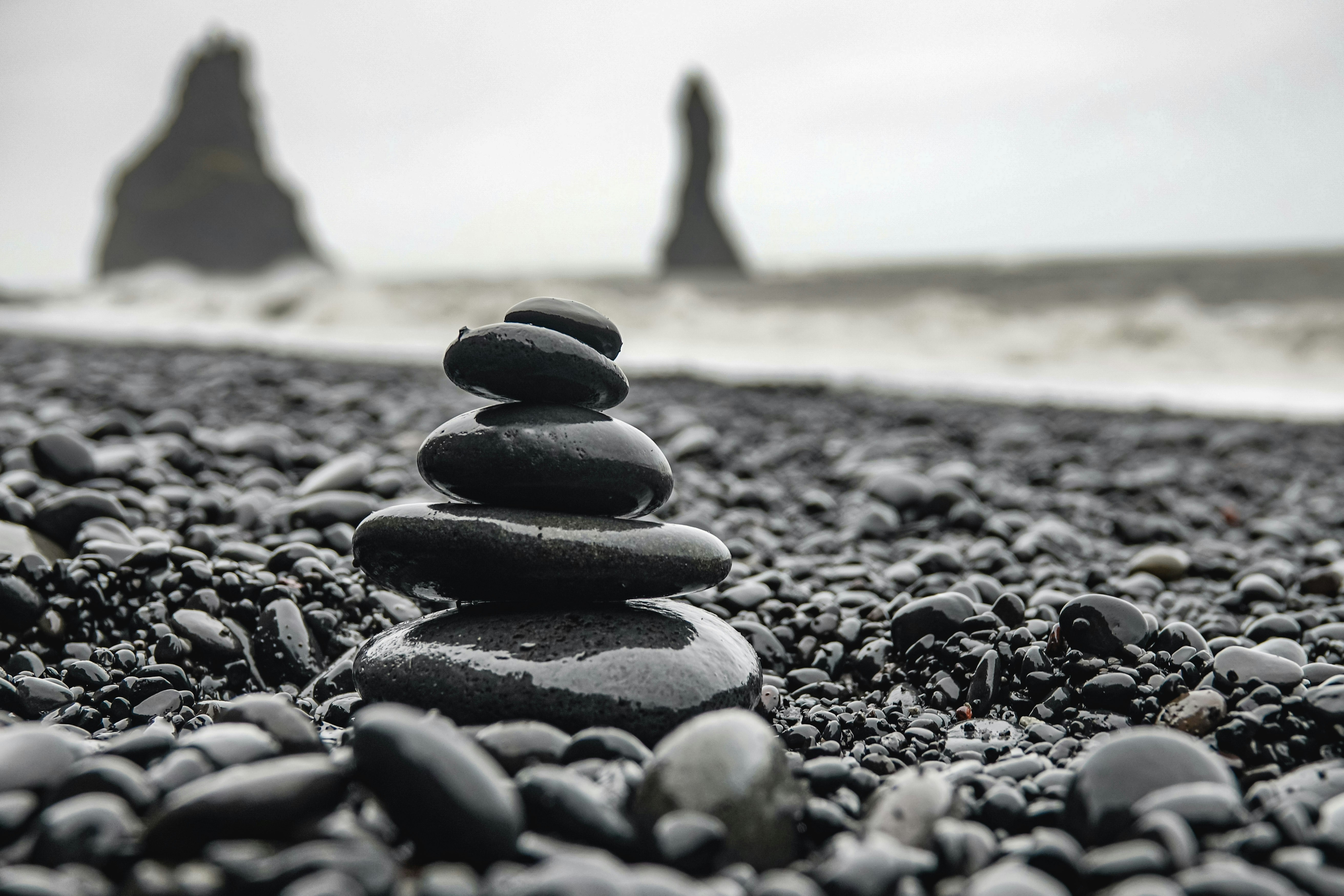 black stones on brown sand during daytime