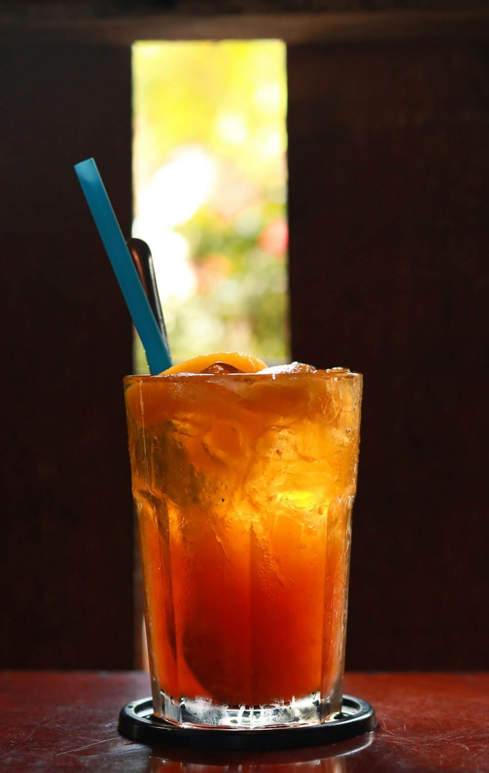 orange juice in clear drinking glass