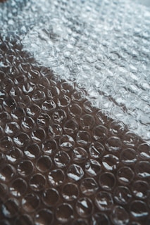 white and red textile on brown surface