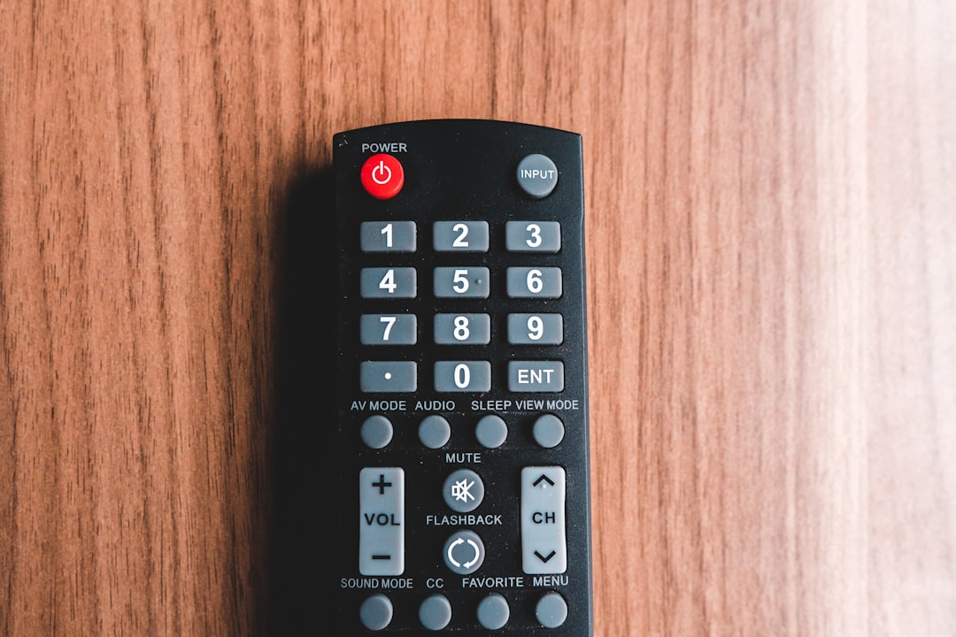 black remote control on brown wooden table