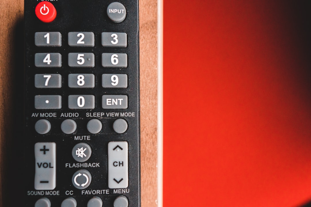 black remote control on red surface