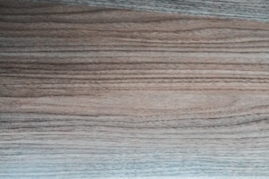 Laminates displaying rich wood grain patterns in warm tones on sample boards.