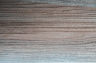 Close-up of grain-pattern mapping displayed on a tablet beside a hardwood floor sample.