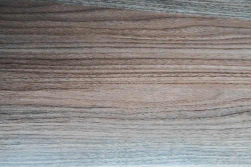 Laminates displaying rich wood grain patterns in warm tones on sample boards.
