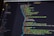 A close-up of a computer screen displaying HTML code in a text editor. The code includes elements such as sections, headers, and paragraphs, with various class attributes for styling. The interface shows file tabs at the top, suggesting it's part of a larger project.