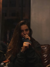 A person happily booking a hair appointment on their phone late at night.