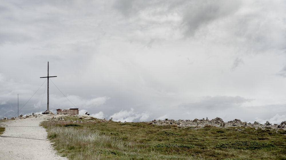 white and brown house on green grass field under white clouds during daytime