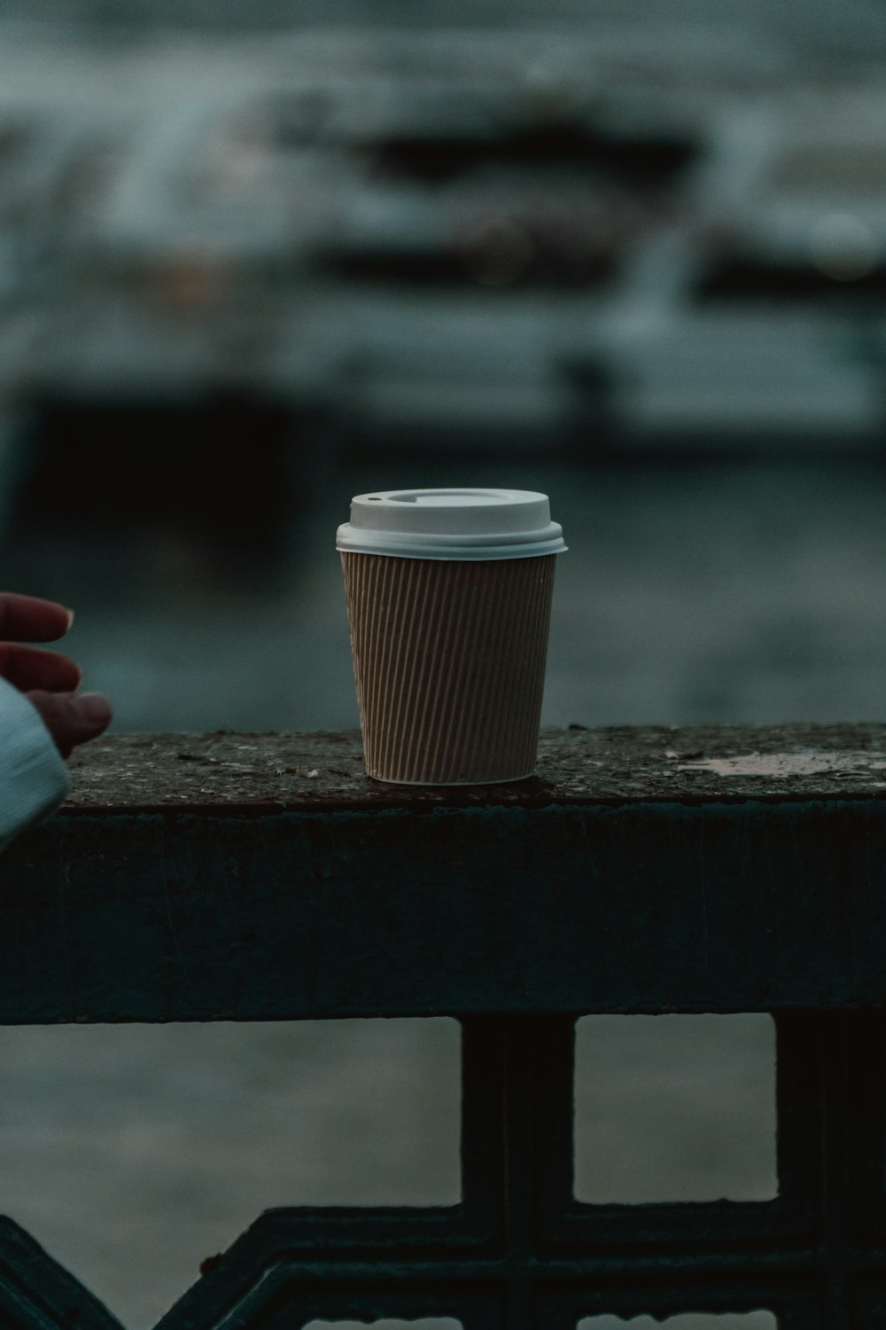 white and brown coffee cup on brown wooden table