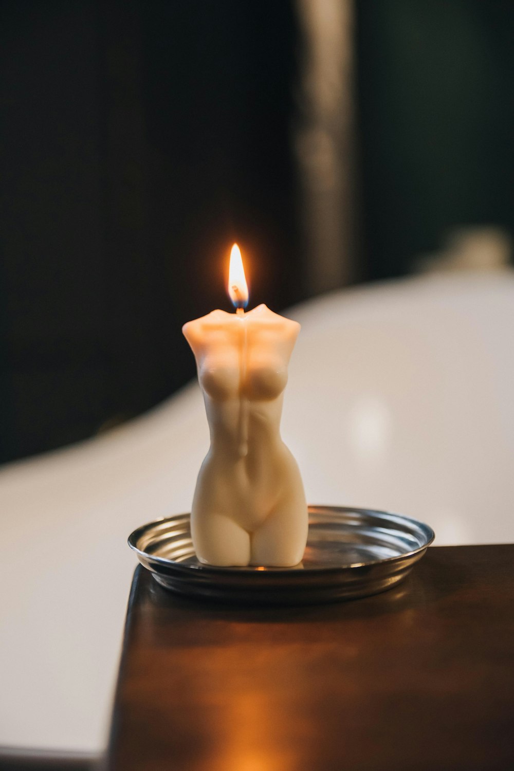 white candle in clear glass holder
