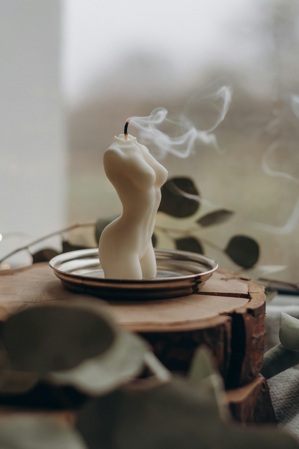 white ceramic candle holder with smoke