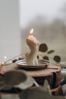 white pillar candle on brown round cake
