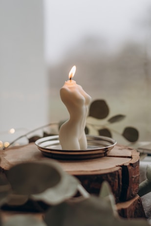 white pillar candle on brown round cake