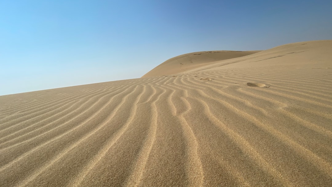 aegle, Soil, brown sand under blue sky during daytime