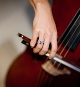 person playing brown acoustic guitar