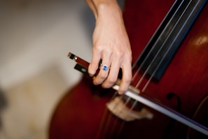 person playing brown acoustic guitar
