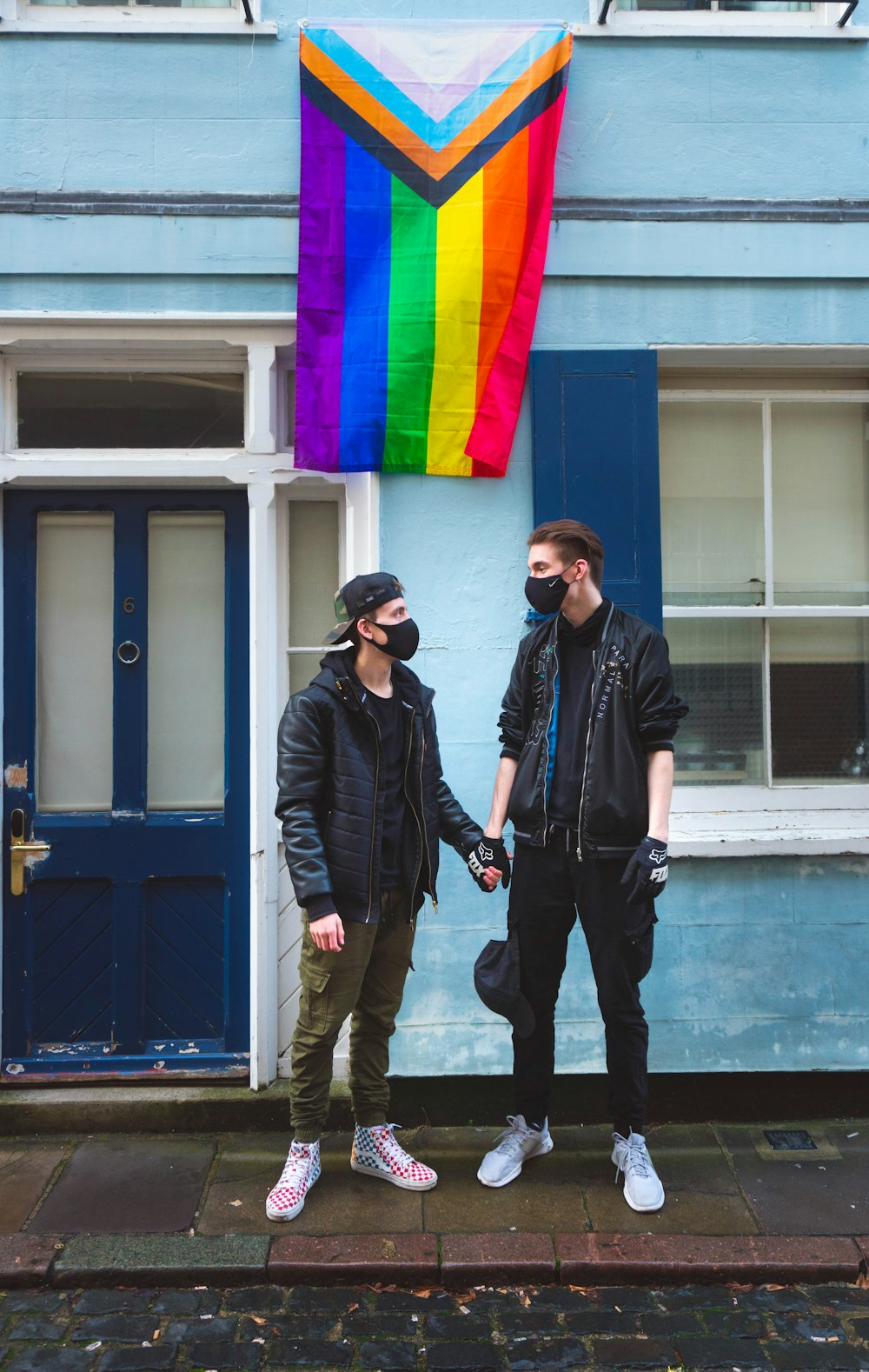 man in black jacket standing beside man in black jacket