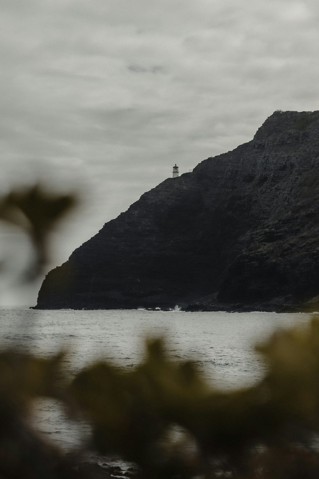 person standing on rock formation near body of water during daytime