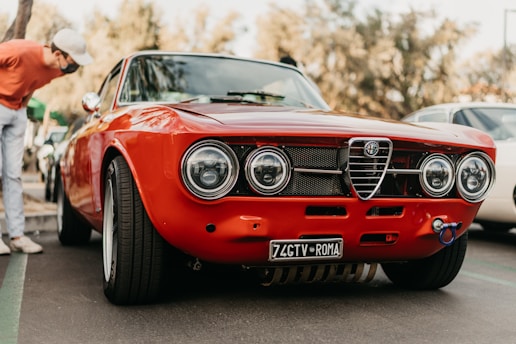 A professional inspecting a classic American car before purchase