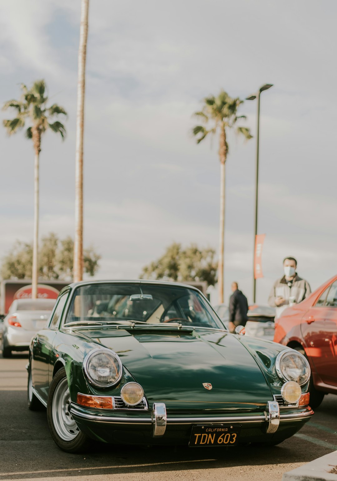 green porsche 911 parked on street during daytime