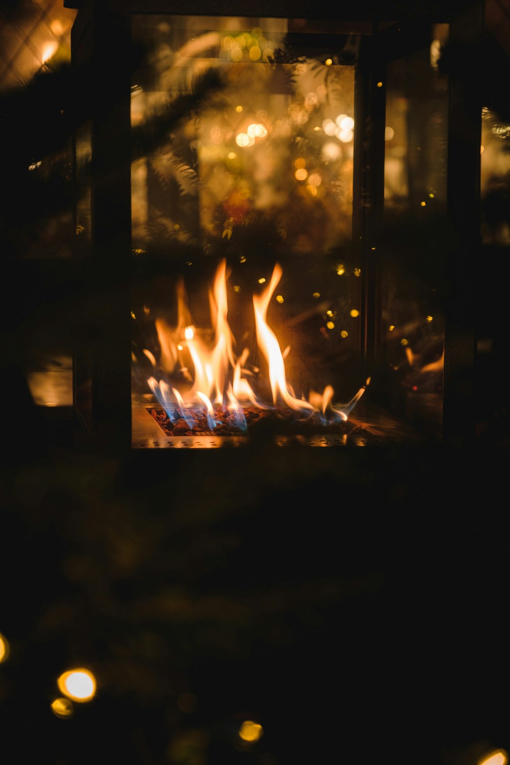 fire in black fireplace with lights turned on during night time