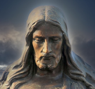 gray concrete statue under blue sky during daytime