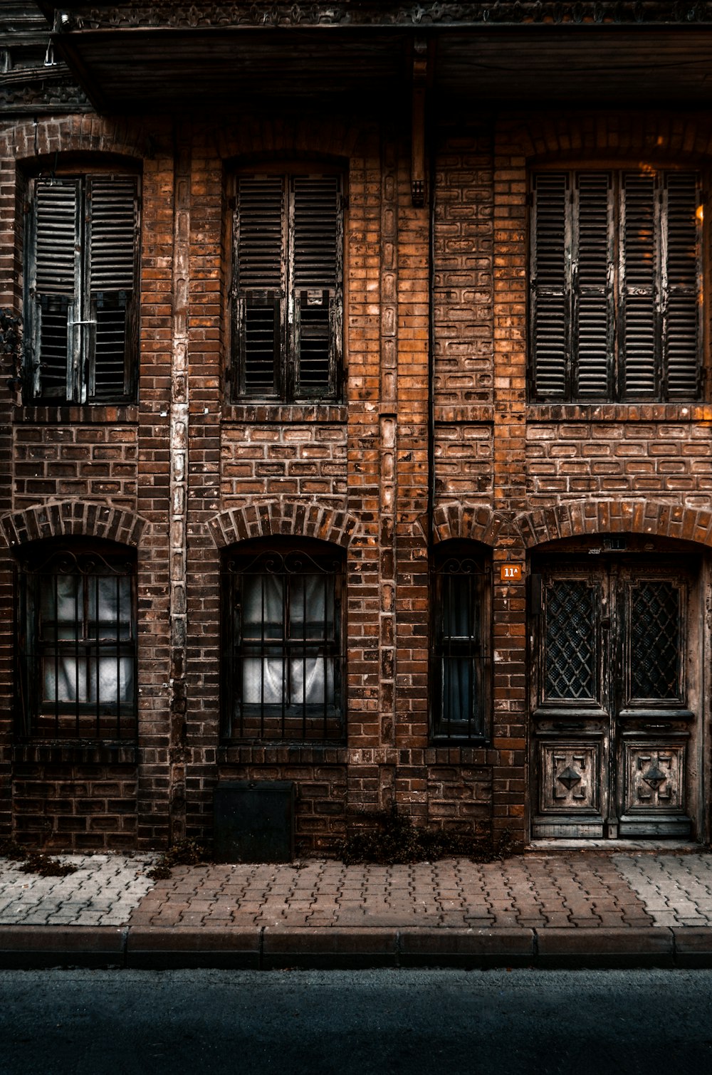 brown brick building with black wooden windows