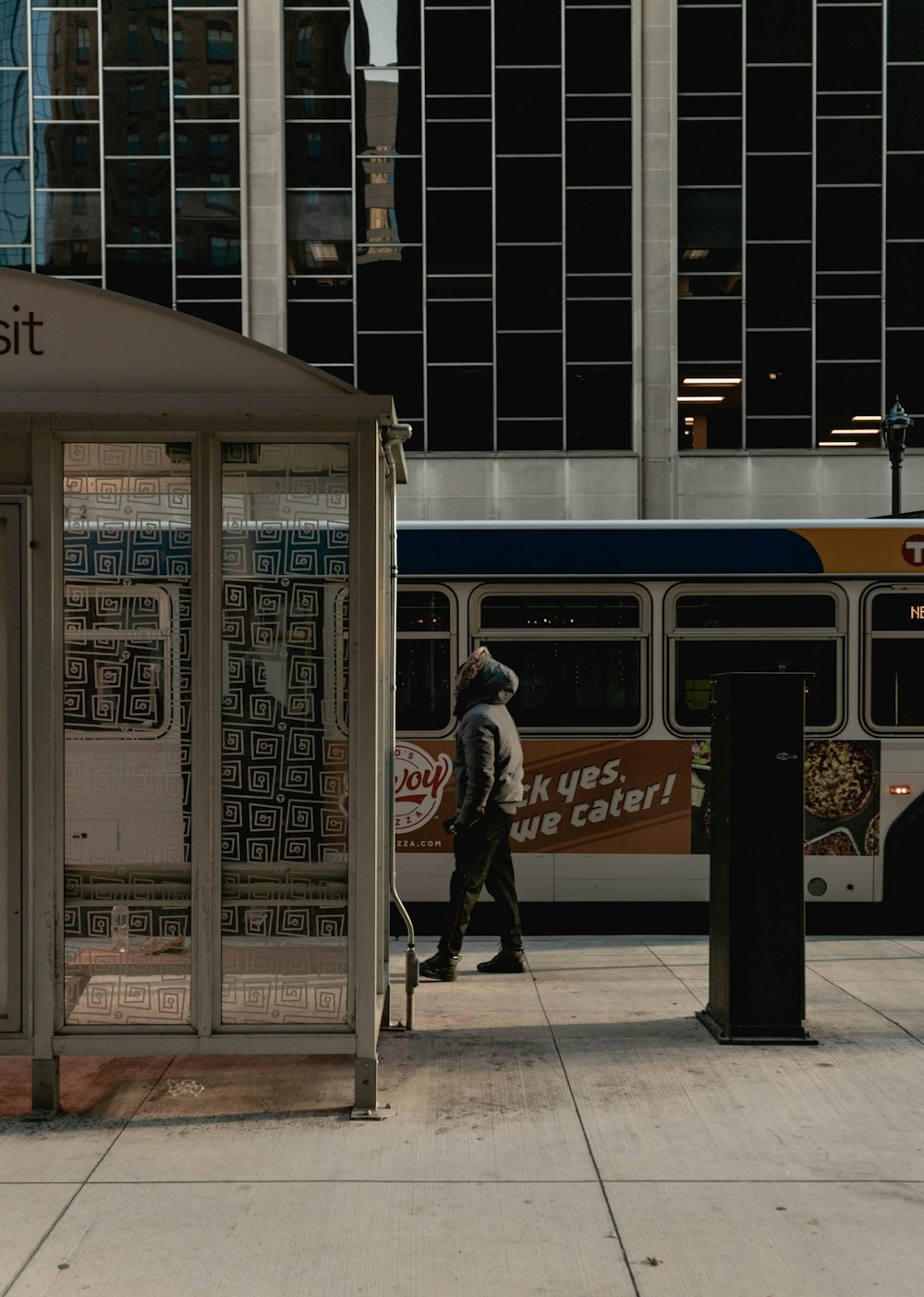 woman in gray jacket standing near white and brown train during daytime