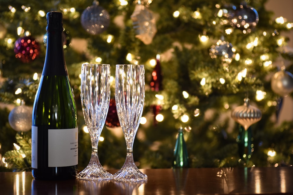 two clear wine glasses on brown wooden table