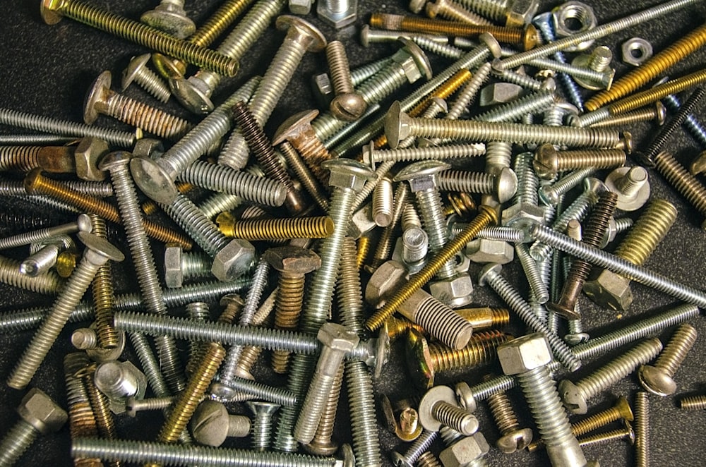 silver screw lot on brown wooden table