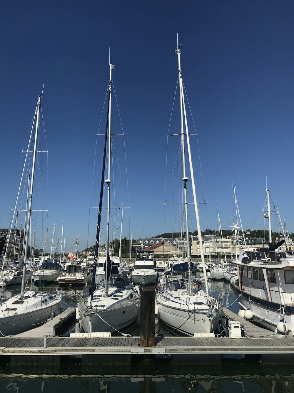 white and blue boat on dock during daytime