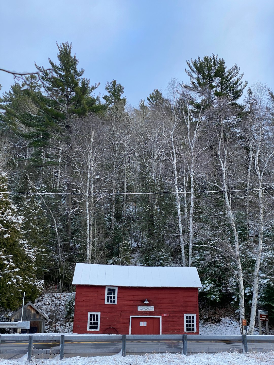 red and white wooden house surrounded by trees during daytime