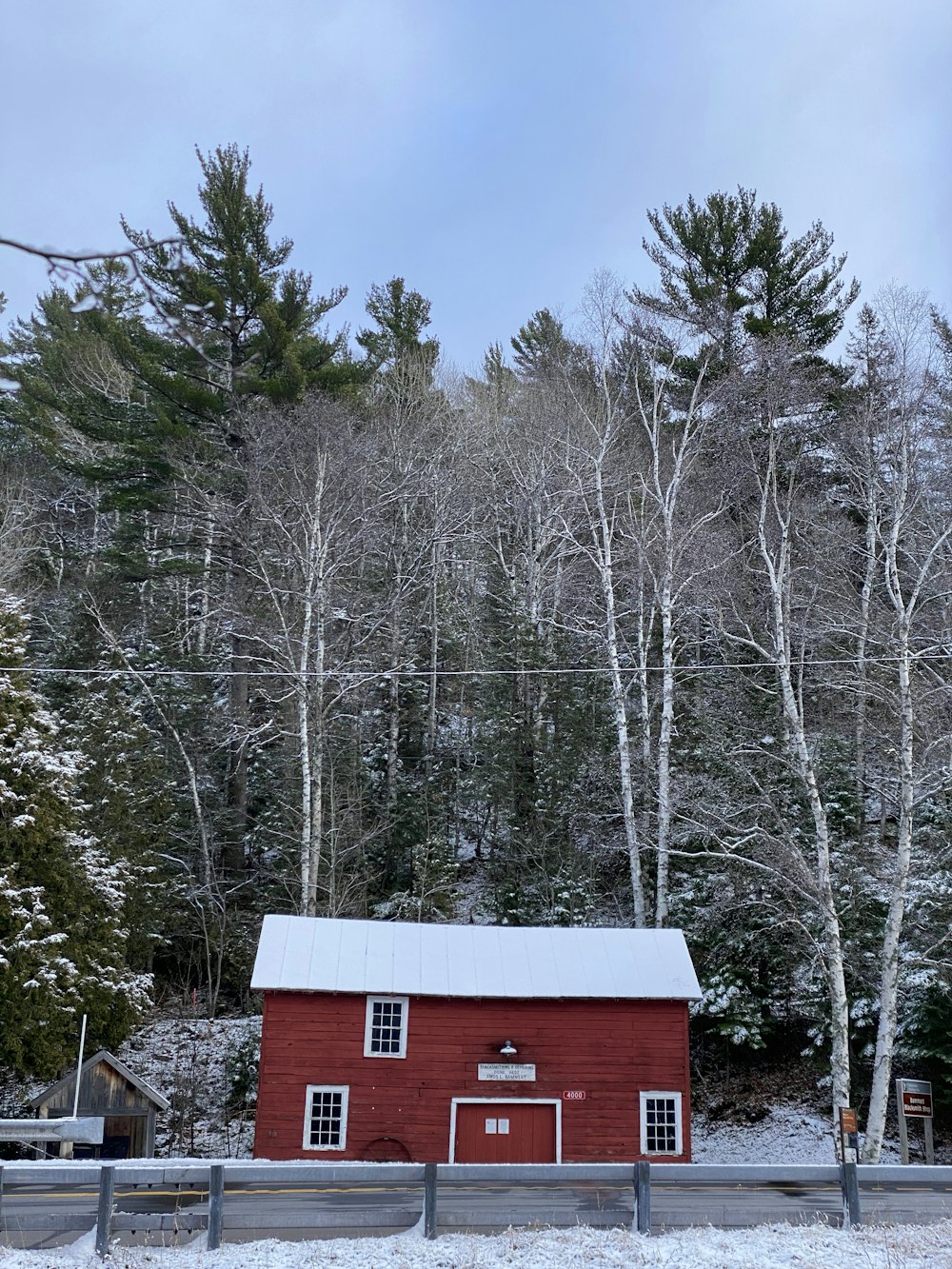 red and white wooden house surrounded by trees during daytime