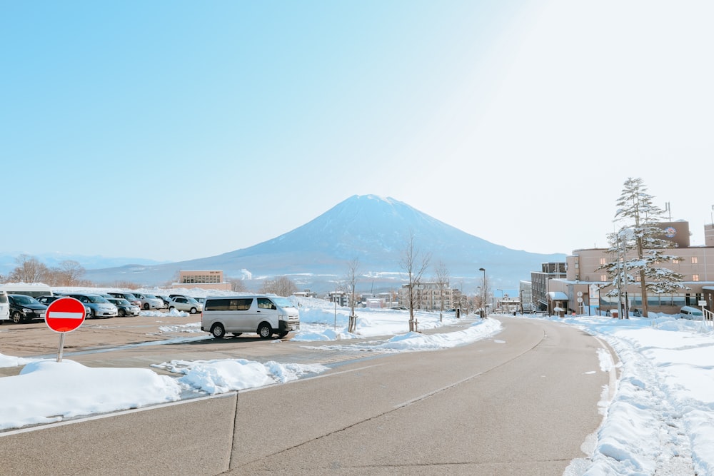 white car on road near snow covered mountain during daytime