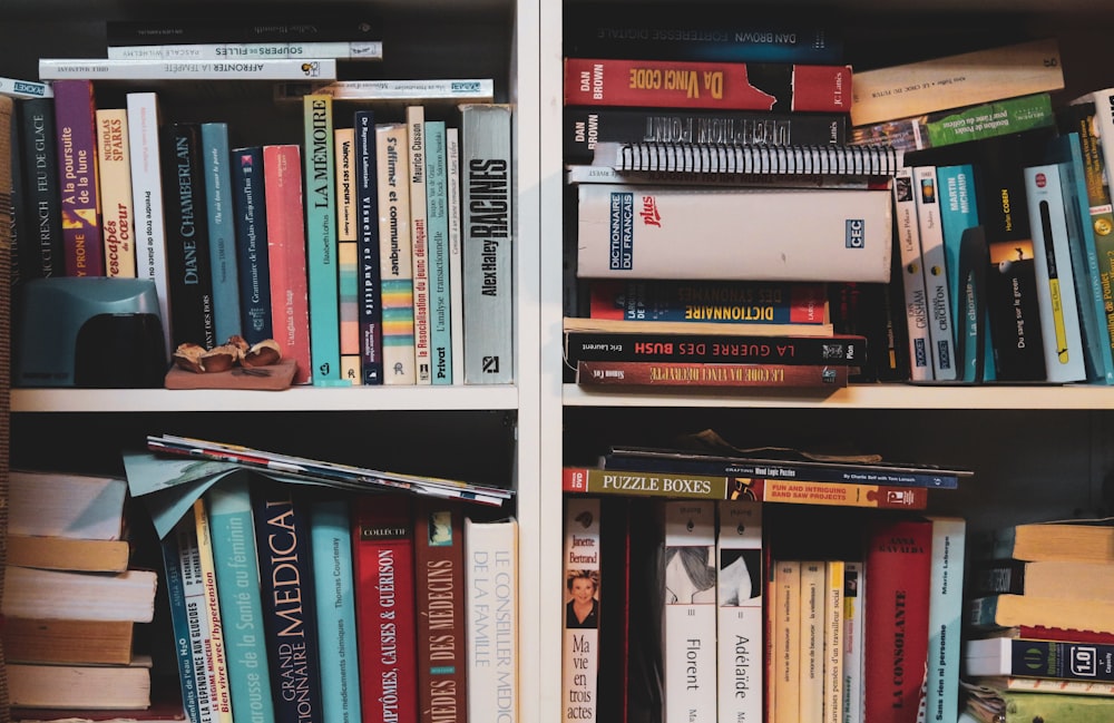 books on white wooden shelf