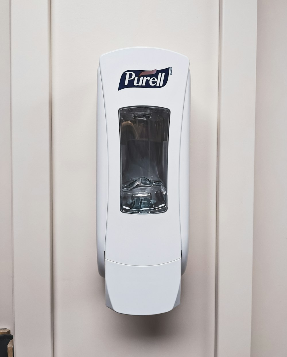 a white paper towel dispenser mounted to a wall